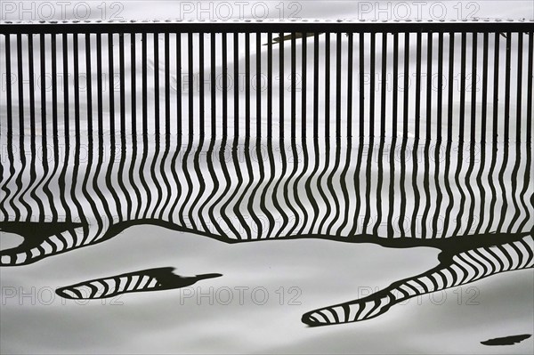 Reflection of a bridge railing in a lake, Germany, Europe