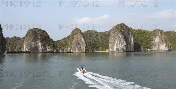 Excursion boat and the karst rocks in Lan Ha Bay, Halong Bay, Vietnam, Asia