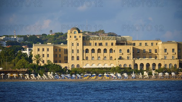 Casino building on the beach with parasols and clear sea, harbour area, Rhodes Town, Rhodes, Dodecanese, Greek Islands, Greece, Europe