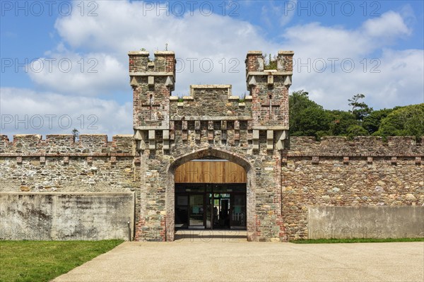 Historic castle with towers and stone walls, surrounded by trees and on a sunny day, Johnstown Castle