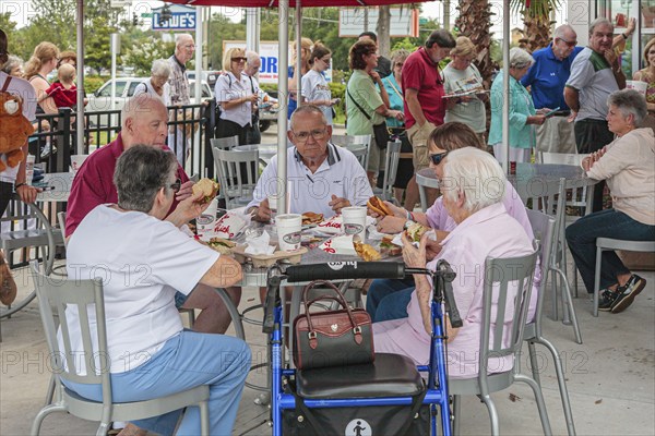 Senior customers eating at the Chick-fil-a fast food restaurant in Ocala, Florida, USA, North America