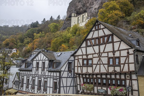 An old half-timbered town in autumn. A church was built into a rock here. Unique German architecture. Foggy landscape in the morning at the rock church, Idar-Oberstein, Rhineland-Palatinate, Germany, Europe
