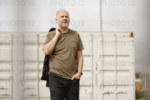Caucasian Man posing in front of industrial background in Albufeira, Algarve, Portugal, Europe