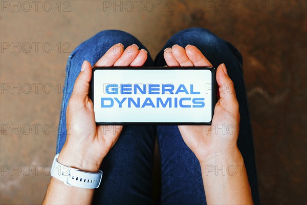 In this photo illustration, the General Dynamics logo is displayed on a smartphone screen