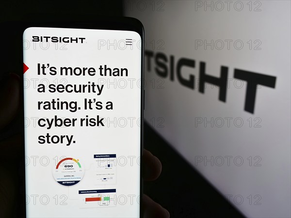 Stuttgart, Germany, 07-14-2024: Person holding mobile phone with web page of cybersecurity ratings company BitSight Technologies Inc. with logo. Focus on center of phone display, Europe