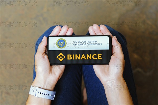In this photo illustration, the Securities and Exchange Commission (SEC) and Binance logo is displayed on a smartphone screen