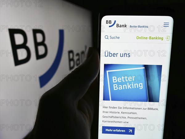Stuttgart, Germany, 07-15-2024: Person holding cellphone with webpage of German financial services company BBBank eG in front of business logo. Focus on center of phone display, Europe