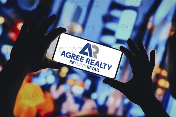 In this photo illustration, the Agree Realty Corporation logo is displayed on a smartphone screen
