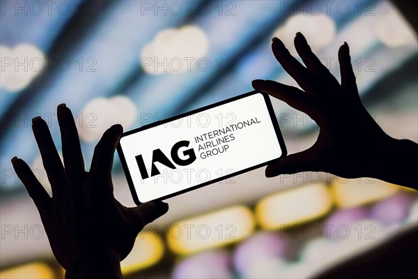 In this photo illustration, the International Airlines Group (IAG) logo is displayed on a smartphone screen