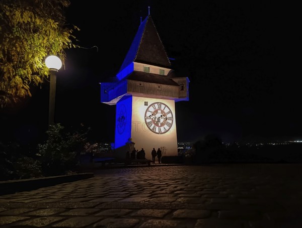 The famous Clock Tower (Grazer Uhrturm) on Shlossberg hill, Graz, Styria region, Austria, by night, Europe