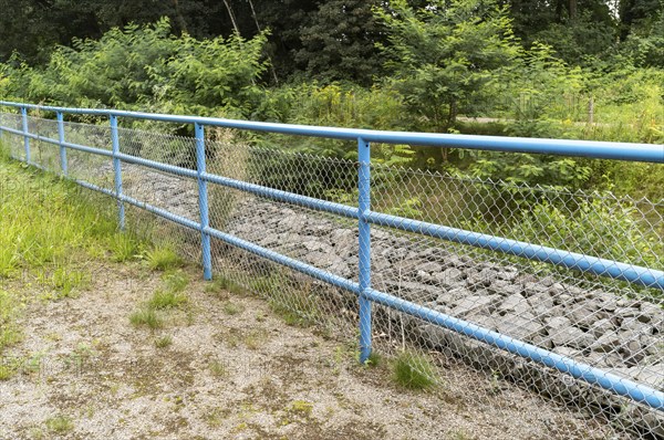 Blue metal railing in the green landscape