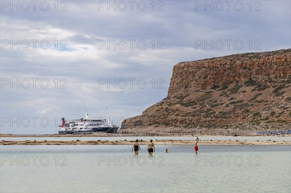 A picture of the blue water and the surrounding landscape of Balos Beach being overlooked by a ferry
