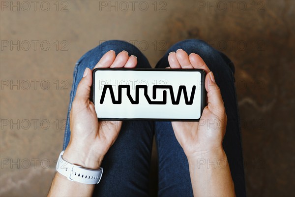 In this photo illustration, the Arrow Electronics logo is displayed on a smartphone screen