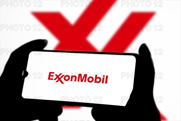 ExxonMobil Corporation Logo on a mobile screen stock image. It's a major multinational publicly traded oil and gas company: