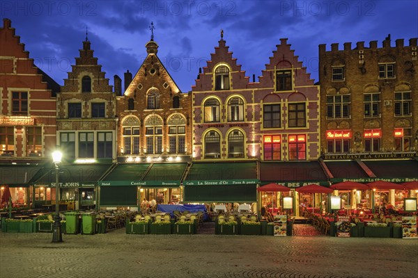 Bruges, Belgium, May 29, 2018: Bruges Grote markt square famous tourist place with many cafe and restaurants in the evening night twilight, Europe