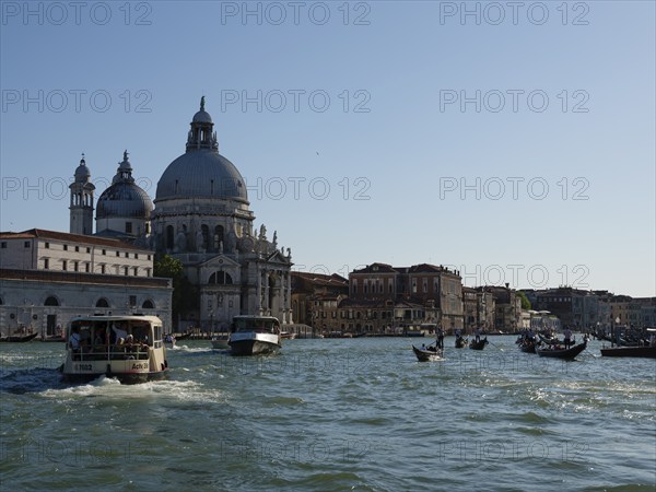 Boats and gondolas on the Grand Canal, with the church of Santa Maria della Salute in the background, Venice, Veneto, Italy, Europe