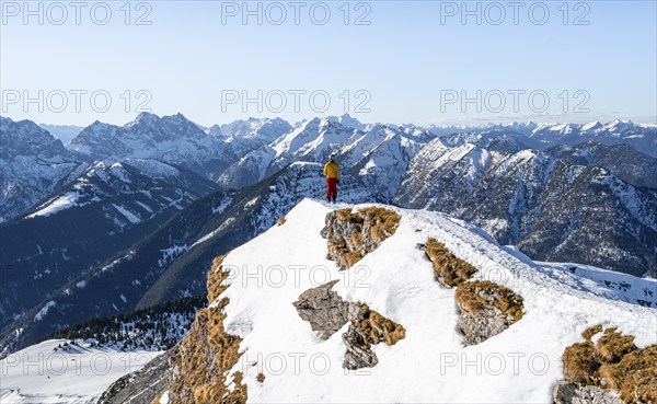 Ski tourers at the summit of Schafreuter, view of snowy mountain panorama, Karwendel, Tyrol, Austria, Europe