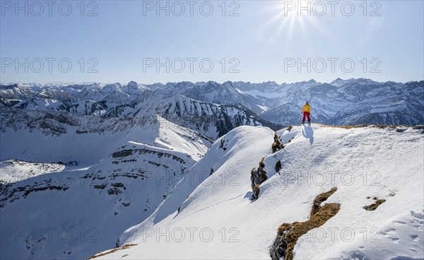 Ski tourers at the summit of Schafreuter, view of snowy mountain panorama, Karwendel, Tyrol, Austria, Europe