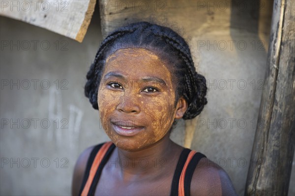 Close up portrait of Malagasy woman with sun protection mask made from the Musiro root in Miandrivazo, Menabe, Madagascar, Southeast Africa, Africa