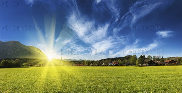 Panorama of German countryside and village on sunset with sun. Bavaria, Germany, Europe