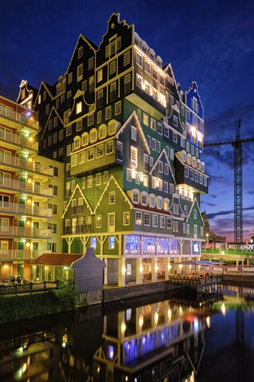 ZAANDAM, NETHERLANDS, MAY 21, 2018: Inntel Hotel in Zaandam illuminated at night. Design of 12-storey tall building opened in 2009 is the result of stacking a series of traditional Dutch houses