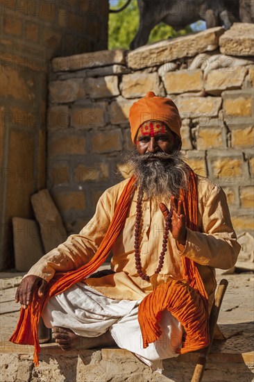 JAISALMER, INDIA, NOVEMBER 28, 2012: Indian sadhu (holy man) blessing. Sadhus are holy men who live ascetic life and focus on spiritual practice of Hinduism