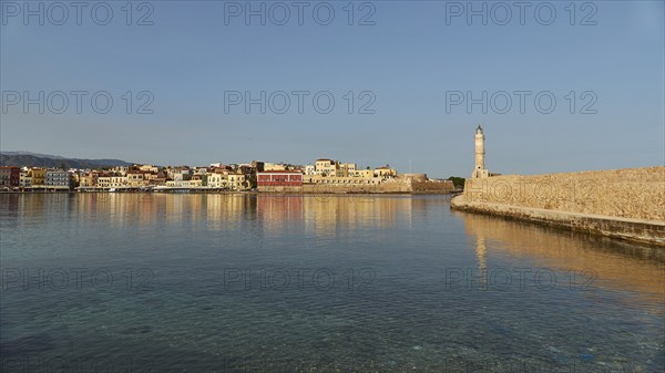 Venetian old town, Venetian harbour, row of houses, colourful houses, Venetian lighthouse, calm sea, blue sea, grey-blue sea, blue cloudless sky, Chania, West Crete, island of Crete, Greece, Europe