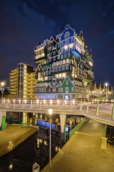 ZAANDAM, NETHERLANDS, MAY 21, 2018: Inntel Hotel in Zaandam illuminated at night. Design of 12-storey tall building opened in 2009 is the result of stacking a series of traditional Dutch houses