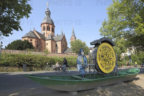 Einhard Basilica of St. Marcellinus and Peter and boat with seal on the road, cyclist, monastery complex, Seligenstadt, Main, Hesse, Germany, Europe