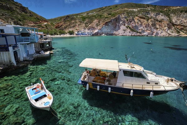 Greek village scenic picturesque view in Greece, fishing boat and fishing village of Firapotamos with beach in Milos island, Greece, Europe