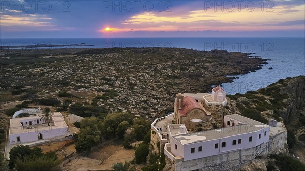 Drone shot, dusk, sunset, cloudy sky, square yard, sea, Chrissoskalitissa, rock monastery, Orthodox monastery, southwest tip, Chania province, Crete, Greece, Europe