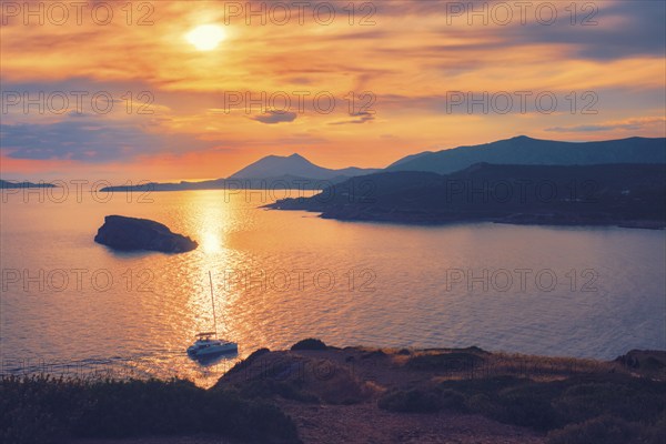 Aegean Sea with Greek islands view on sunset with yacht in sea. Cape Sounion, Greece, Europe