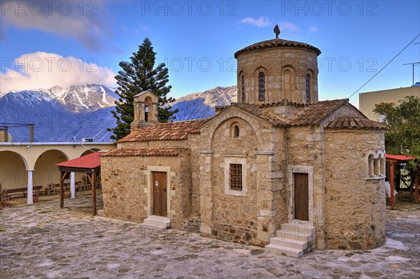 Byzantine church, dome, bell centre, tree, snow-capped mountains, cloudy blue sky, Myriokephala, Orthodox monastery, Crete, Greece, Europe