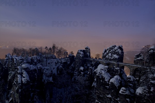 Bastei rock at full moon in winter