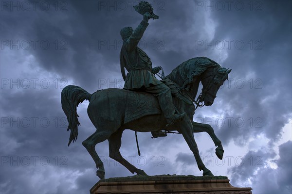 Silhouette of the equestrian statue of King Vittorio Emanuele III, rain clouds, Piazza Corvetto, Genoa, Italy, Europe