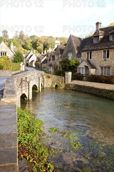 Bybrook River running past stone cottages in Castle Combe, Wiltshire, England, UK claimed to be England's prettiest village