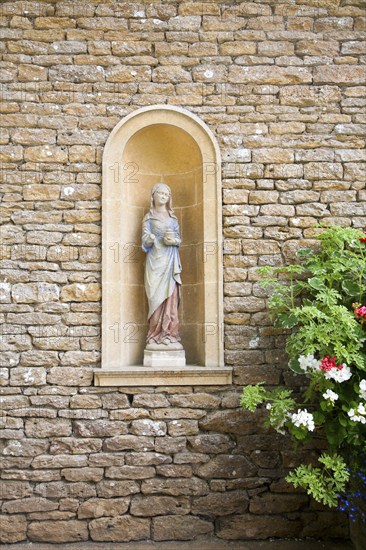 Statue detail in Italianate garden of landscape gardener Harold Ainsworth Peto created between 1899 and 1933, at Iford Manor, Bradford on Avon, Wiltshire, England, United Kingdom, Europe