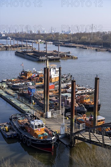 Hamburg harbour, Travehafen, working boats and barges, jetty, city skyline in the background, Hamburg, Germany, Europe