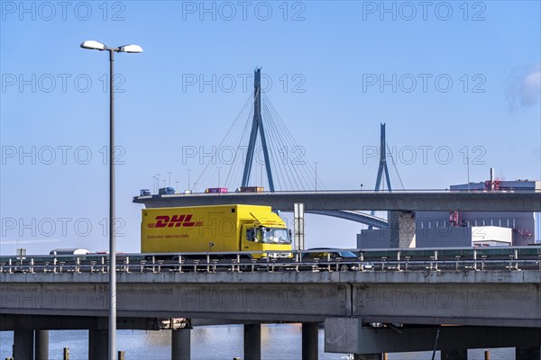 The Köhlbrand Bridge in the port of Hamburg, in front traffic on the A7 motorway, spans the 325 m wide Köhlbrand, an arm of the Süderelbe, the bridge is over 3600 metres long, 53 metres above the water, piers 135 m high, more than 30, 000 vehicles use the B3 bridge daily, important connection to the port, it is dilapidated, to be rebuilt, Hamburg, Germany, Europe