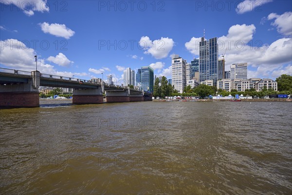 Untermainbrücke, Main river and skyscrapers under blue sky with cumulus clouds in Frankfurt am Main, Hesse, Germany, Europe