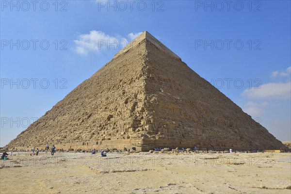 The Great Pyramid of Giza under a clear blue sky with a few scattered clouds, surrounded by tourists, Giza, Cairo, Egypt, Middle East, North Africa, Africa