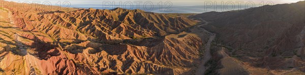 Aerial view, eroded mountain landscape, sandstone cliffs, canyon with red and orange rock formations, Farytale Canyon Skazka, Issyk Kul, Kyrgyzstan, Asia