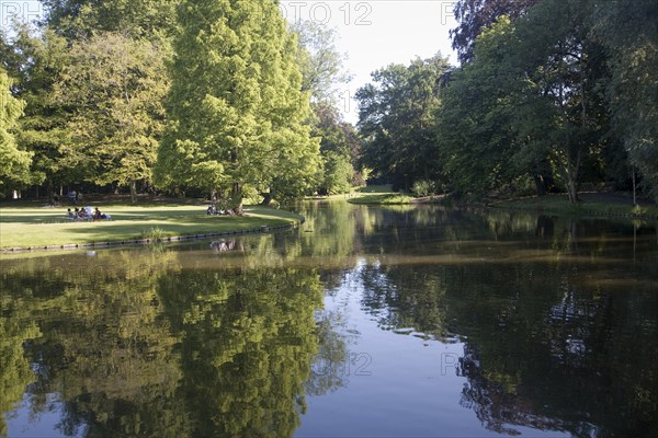 People in summer enjoying the greenery and calm of Het Park, central Rotterdam, Netherlands