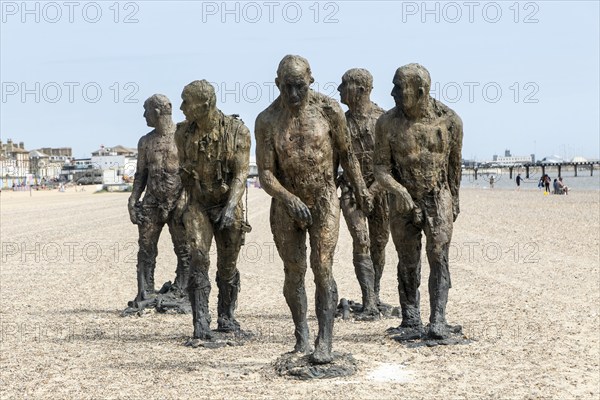 'Walking Men' artwork bronze sculptures by Laurence Edwards, South Beach, Lowestoft, Suffolk, England, UK July 2024