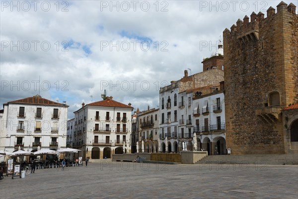 A large square with old buildings, a tower and cafés on the edge, tower, Torre de Bujaco on the right, Plaza Mayor, Cáceres, Caceres, Extremadura, Spain, Europe
