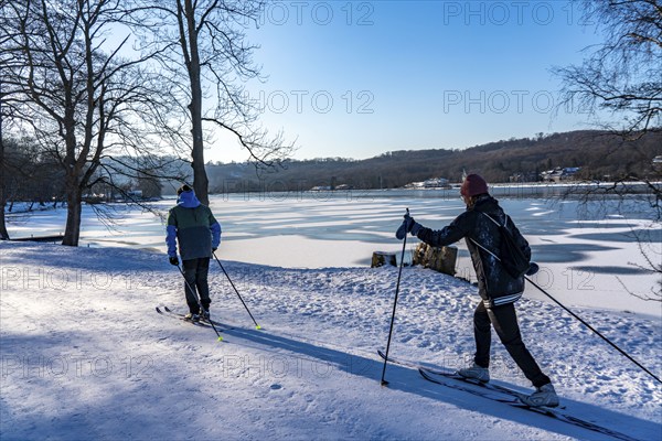 Winter in the Ruhr area, Lake Baldeney, snowy, partly frozen lake, Essen, cross-country skier, North Rhine-Westphalia, Germany, Europe