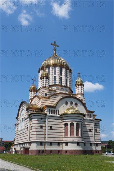 A church with golden domes and a Christian cross under a blue sky, Orthodox Cathedral of St John the Baptist, Fagaras, Fagara?, Fogarasch, Fugres Market, Brasov, Transylvania, Romania, Europe