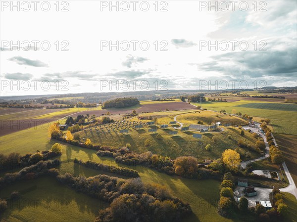 Aerial view of an extensive rural autumn landscape with fields and small buildings, solar park. Horb, Black Forest, Germany, Europe