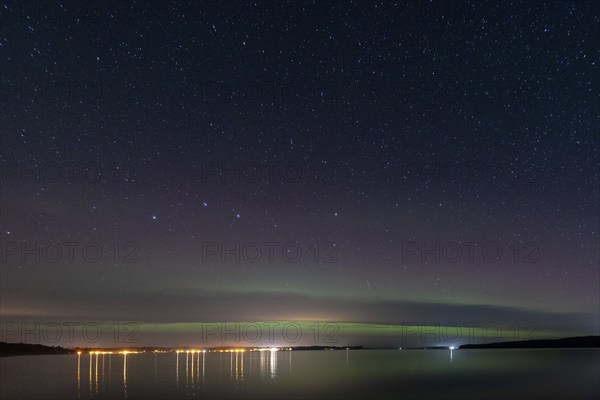 Northern lights (aurora borealis) shine on a starry night over Lake Plau, Ganzlin, Mecklenburg-Vorpommern, Germany, Europe