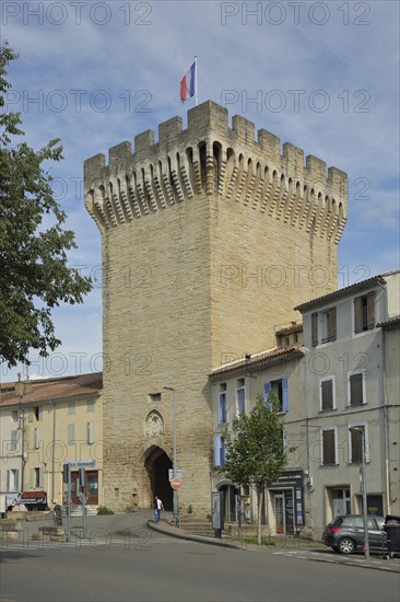 Porte d'Orange, city gate with battlements and French national flag, defence defence tower, Carpentras, Vaucluse, Provence, France, Europe